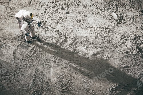 Preview: High angle shot of an astronaut miniature toy on the moon