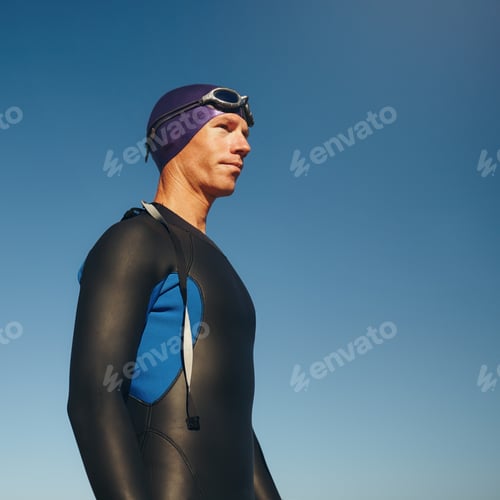 Preview: Determined male triathlete in wetsuit