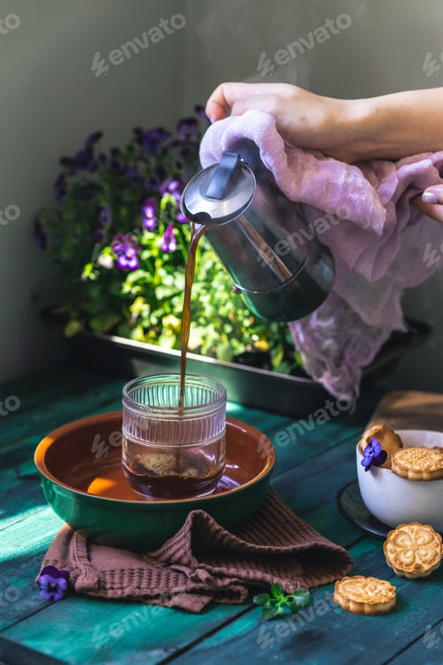 Preview: coffee in transparent cup with homemade cookies - selfish breakfast. Green wooden table with pansies
