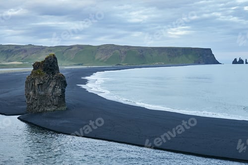 Preview: Impressive view of famous rock on a black sand beach in Iceland