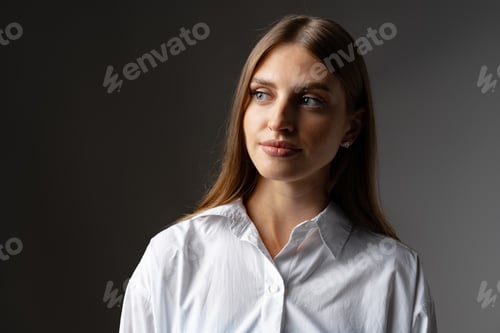 Preview: Thoughtful businesswoman portrait on a dark gray background