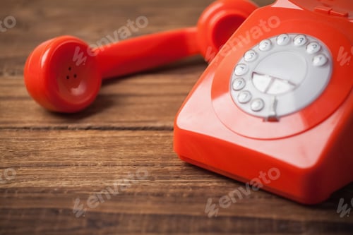 Preview: Red telephone on wooden table with copy space