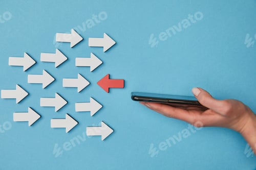 Preview: cropped view of woman holding smartphone near red horizontal pointer opposite white arrows on blue