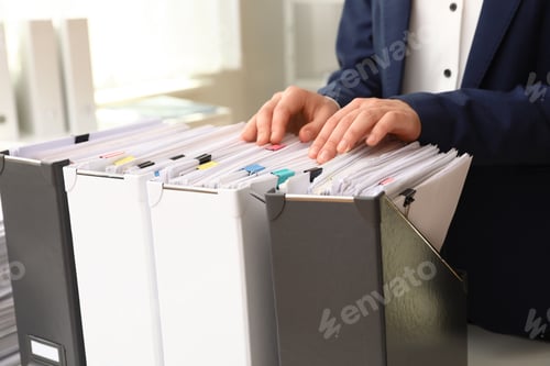 Preview: Woman taking documents from folder in archive, closeup