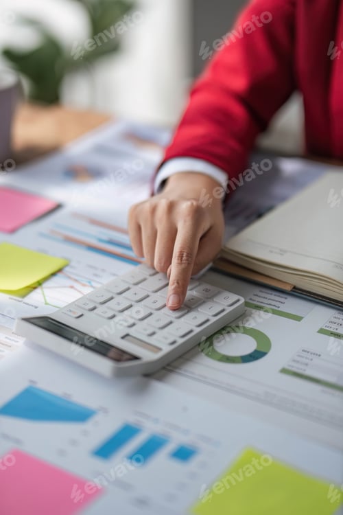 Preview: Asian female accountant or banker making calculations. Savings, finances and economy concept.