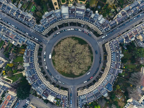 Preview: Aerial view of a circle square with three roads and parked cars in a beautiful city