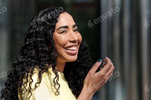 Preview: Lovely young woman laughing in the street.