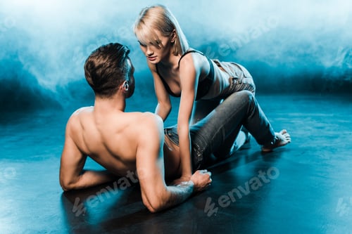 Preview: seductive couple lying on blue smoky background