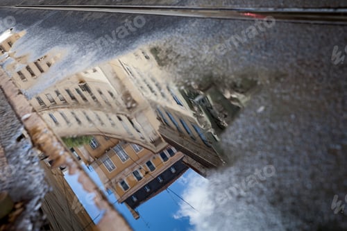 Preview: Reflection of the building in a puddle