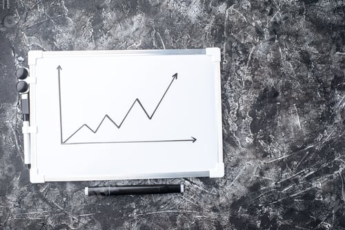 Preview: Close up view of a white desk with chart drawing on gray distressed background with free space