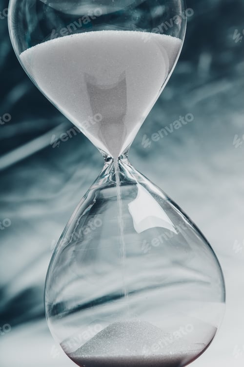 Preview: Hourglass steadily measuring time with sand flowing in a minimalist setting