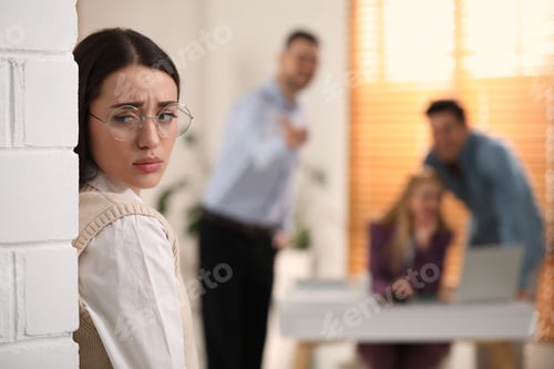 Preview: Coworkers bullying their colleague in office, space for text