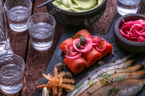 Preview: Close view of cured salmon with shots of vodka.