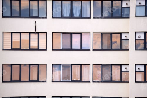 Preview: Architectural details of modern high apartment building facade with many windows and balconies