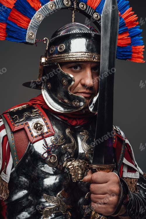 Preview: Roman legionnaire posing with sword isolated on gray