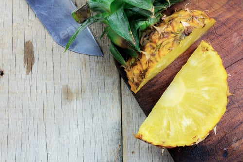 Preview: Pineapple of cut on wooden.