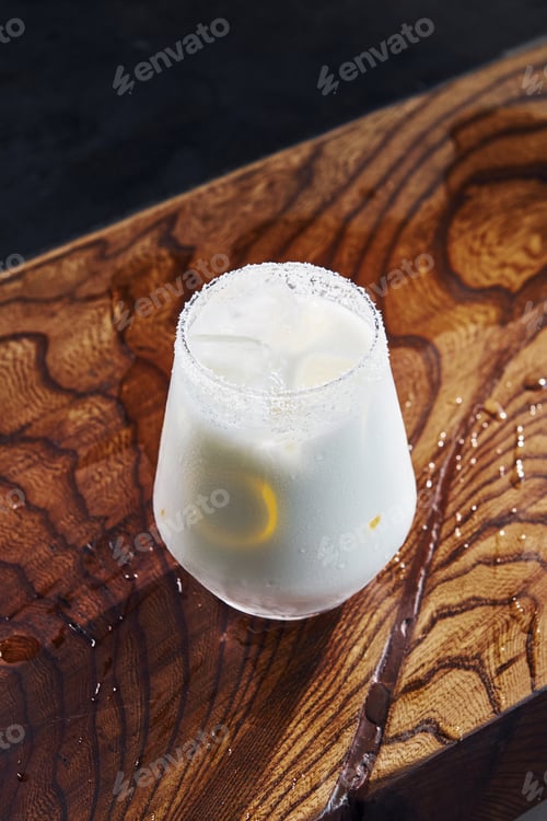 Preview: Slice of lemon inside. Close up view of fresh summer cocktail on the wooden table