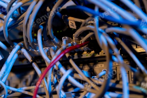 Preview: close-up of a pile of network patch cables sorted in a rack cabinet leading from a patch panel