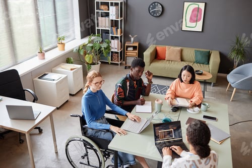 Preview: Diverse IT team meeting at table in office and discussing project