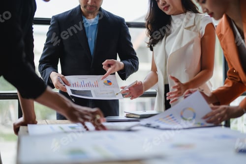 Preview: Business team analyzing financial charts and graphs during a meeting