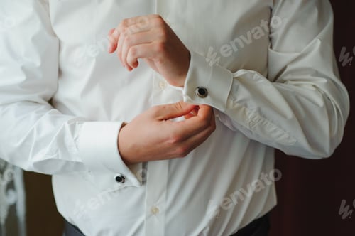 Preview: A businessman dresses a white shirt close-up, the groom prepares for the wedding ceremony.