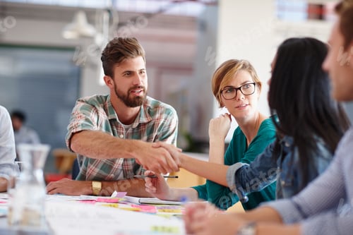 Preview: Shot of a male designer shaking hands with a colleague during a meeting