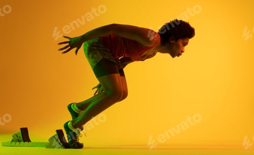 Preview: Image of african american female athlete preparing for run in yellow lighting