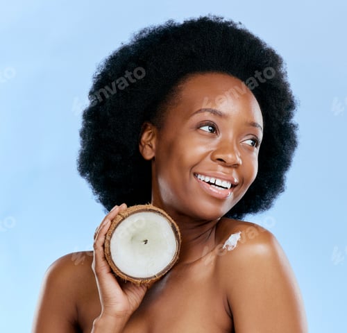 Preview: Beauty, skin and coconut with a model black woman in studio on a blue background for natural treatm