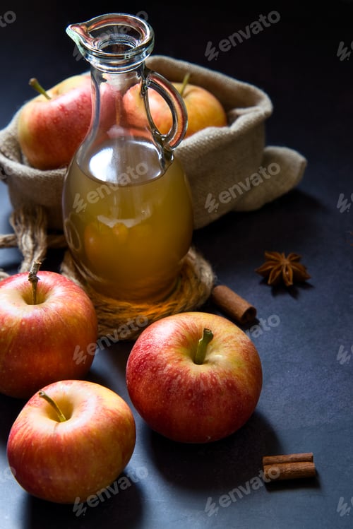 Preview: Apple juice with cinnamon in rustic composition.