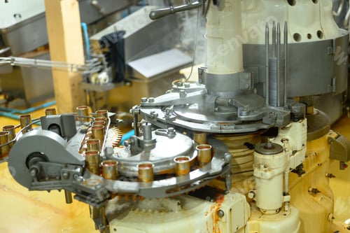 Preview: Close up of automated food processing machinery filling metal cans in a factory