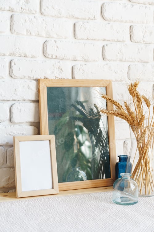 Preview: Mockup with a frame and dry flowers in a vase on a white table