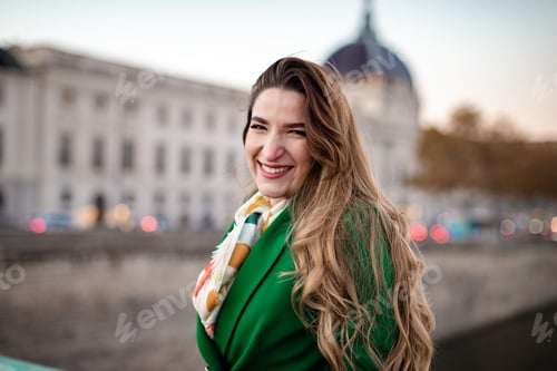 Preview: Young woman wearing green smiling at camera