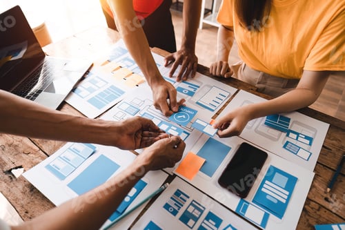 Preview: Close up ux developer and ui designer brainstorming about mobile app interface wireframe design at