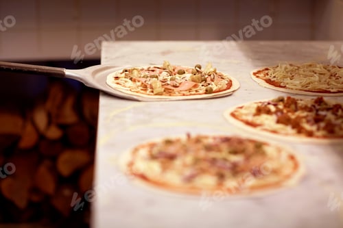 Preview: peel taking pizza off table at pizzeria