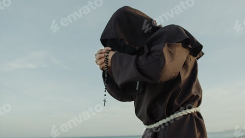 Preview: Religious Monk Prays Alone The Rosary Crucifix Lonely In Nature