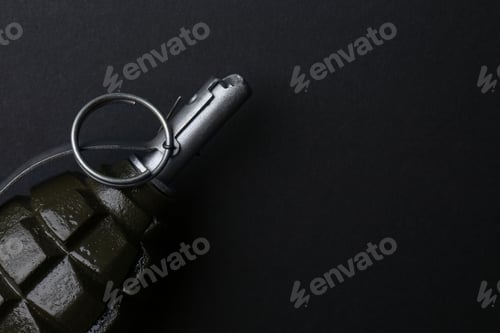 Preview: Hand grenade on black background, closeup. Space for text