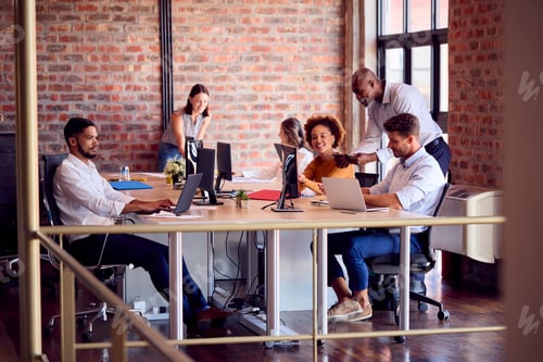 Preview: Business Team Working Together In Busy Multi-Cultural Office