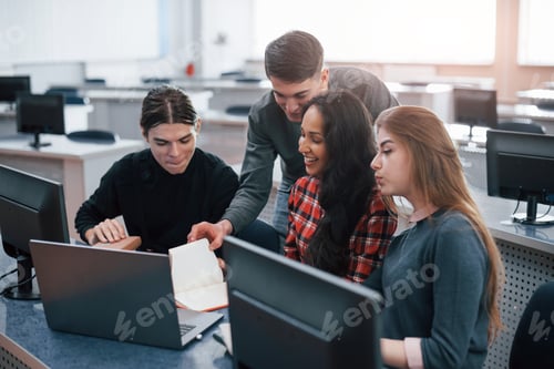 Preview: Group of young people in casual clothes working in the modern office