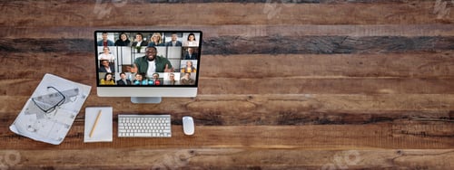 Preview: Panoramic photo, top view of computer screen standing on wood desk, with group of multiracial people