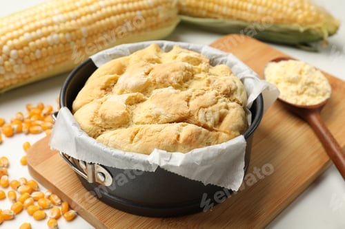 Preview: Freshly baked cornbread, seeds, flour and cobs on white table, closeup