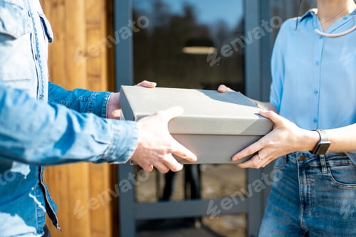 Preview: Delivery man bringing shoes to a woman