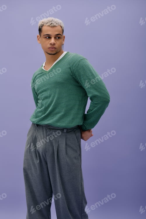 Preview: Young african american man showcases unique fashion style against purple backdrop