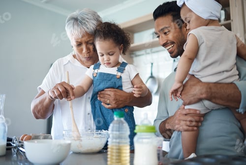 Preview: Shot of a woman baking in the kitchen with her son and two grandchildren