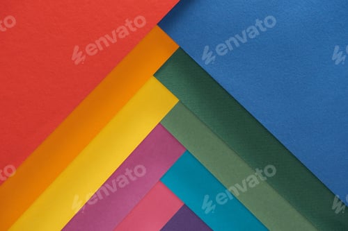 Preview: top view of colorful red, burgundy, blue, orange, green, yellow, pink and purple sheets of paper