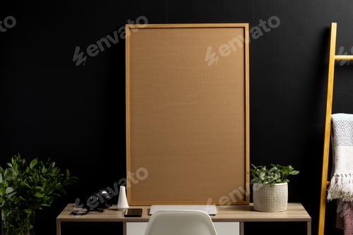 Preview: Wood empty frame with copy space, plants and technology devices on desk against black wall
