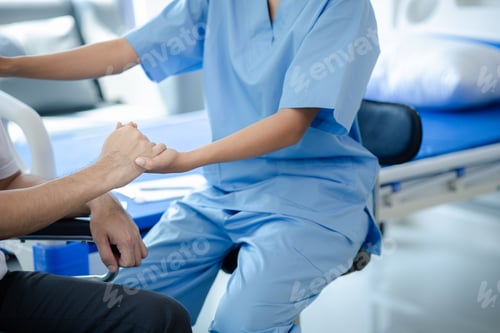 Preview: Male patient sitting in wheelchair undergoing a medical examination with specialist physician, treat