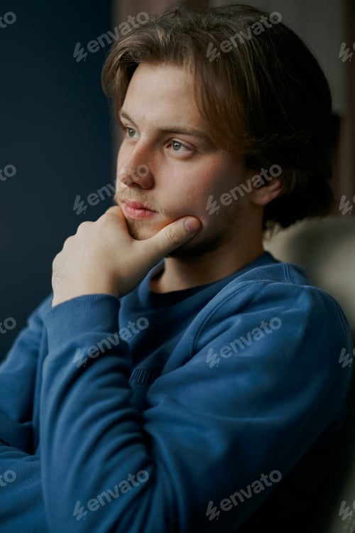 Preview: young businessman working on laptop computer at home office