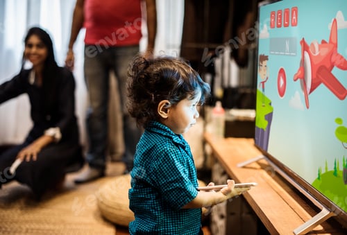Toddler Playing Educational Game on Television at Home