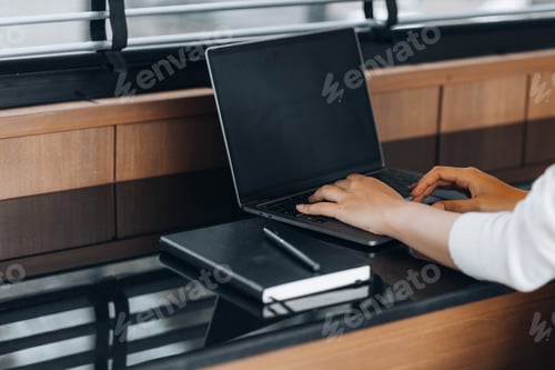 Preview: Businessman typing on a laptop keyboard, he is filling out his credit card information.