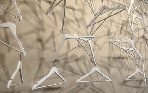 Preview: Empty wooden clothes hangers casting deep shadows